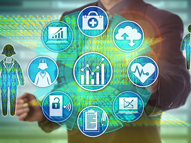 A man is touching a screen with medical icons on it