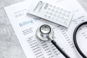 medical treatmant billing statement with stethoscope and calculator