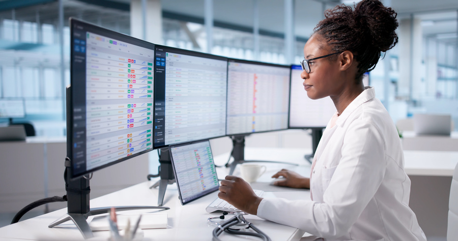 Young African American Woman Coding Medical Bills In Hospital Office