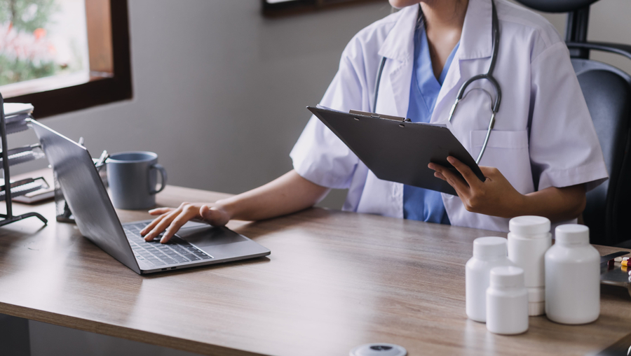 allergy clinic doctor working on bills